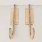 Wooden wall hooks for hanging coats or accessories.